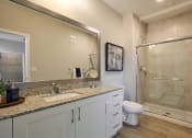 Thumbnail 4 of 29 - a bathroom with a sink and a shower and a toilet
