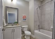 Thumbnail 8 of 29 - a bathroom with a shower toilet and sink and a mirror