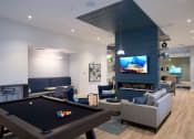 Thumbnail 26 of 29 - a living room with a pool table and a tv