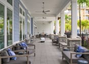 Thumbnail 18 of 29 - a porch with couches and chairs on a patio