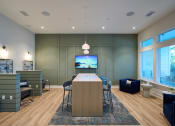 Thumbnail 21 of 29 - a conference room with a table and chairs and a television