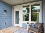 Thumbnail 5 of 29 - a chair and a table on a porch next to a door