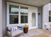 Thumbnail 11 of 29 - a front porch with a chair and a yellow vase on it