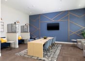 Thumbnail 13 of 92 - a conference room with a blue accent wall and a wooden table