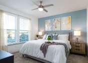 Thumbnail 9 of 92 - a bedroom with a large bed and a ceiling fan