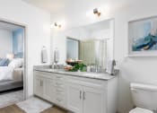 Thumbnail 23 of 92 - a white bathroom with a large mirror and a toilet