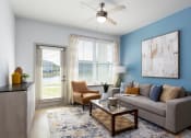 Thumbnail 17 of 92 - an open living room with blue walls and a ceiling fan