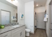Thumbnail 22 of 92 - a bathroom with a toilet sink and mirror and a shower
