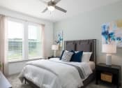 Thumbnail 20 of 92 - a bedroom with a bed and a ceiling fan