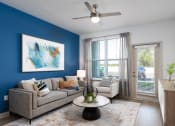 Thumbnail 18 of 92 - a living room with a blue accent wall and a couch