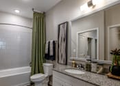 Thumbnail 6 of 31 - a bathroom with a shower and a toilet and a sink