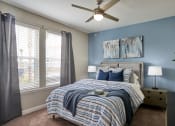 Thumbnail 10 of 29 - a bedroom with a large bed and a ceiling fan