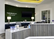 Thumbnail 13 of 29 - the law firm reception desk with green turf wall behind it