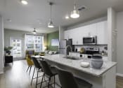 Thumbnail 1 of 29 - an open kitchen and living room with a granite counter top