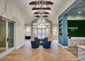 Thumbnail 20 of 29 - a lobby with blue chairs and a green wall and glass doors