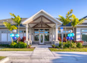 Thumbnail 24 of 54 - the front entrance of a building with palm trees and balloons