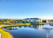 Thumbnail 12 of 54 - an aerial view of a lake with buildings and a fountain
