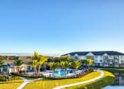 Thumbnail 15 of 54 - an aerial view of a resort with a swimming pool and palm trees