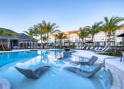 Thumbnail 13 of 54 - a large swimming pool with lounge chairs and palm trees