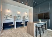 Thumbnail 40 of 54 - a communal area with a bar and a tv in a hotel room