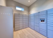 Thumbnail 36 of 54 - a large locker room with blue lockers and a wooden floor