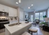 Thumbnail 44 of 54 - an open kitchen and living room with a large white counter top