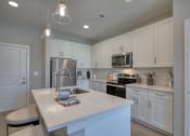 Thumbnail 48 of 54 - a kitchen with white cabinets and a white counter top