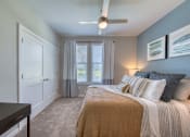 Thumbnail 53 of 54 - a bedroom with a large bed and a ceiling fan