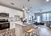 Thumbnail 45 of 62 - A modern kitchen with a center island and stools.