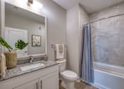 Thumbnail 50 of 62 - A bathroom with a toilet, sink, and bathtub.