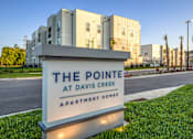 Thumbnail 42 of 62 - A sign for The Pointe at Davis Creek Apartment Homes is in front of a building.