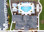 Thumbnail 27 of 62 - A bird's eye view of a residential area with a swimming pool.