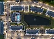 Thumbnail 31 of 62 - A large complex with a lake in the middle.