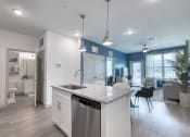 Thumbnail 4 of 92 - a kitchen and living room with blue and white walls and a white counter top with
