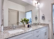 Thumbnail 85 of 92 - a bathroom with two sinks and a large mirror