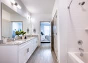 Thumbnail 86 of 92 - a white bathroom with a shower and a sink and a tub