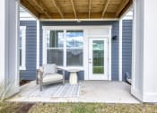 Thumbnail 83 of 92 - a front porch with a chair and a table on it