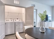 Thumbnail 76 of 92 - a kitchen and dining room with a table and chairs and a washer and dry