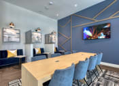 Thumbnail 61 of 92 - a conference room with blue chairs and a wooden table