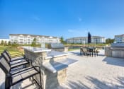 Thumbnail 55 of 92 - the preserve at ballantyne commons outdoor patio with tables and chairs and a grill
