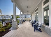 Thumbnail 57 of 92 - the front porch of a home with benches and a view of the water