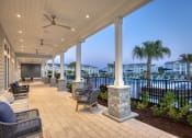 Thumbnail 40 of 92 - a covered porch with a view of the water and palm trees