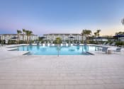 Thumbnail 45 of 92 - a large pool with chairs and chairs around it in front of a resort