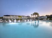 Thumbnail 47 of 92 - a large swimming pool with white chairs in front of a resort