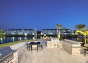 Thumbnail 41 of 92 - a patio with a table and chairs next to a body of water
