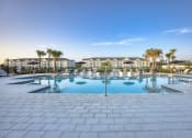 Thumbnail 48 of 92 - a large swimming pool with chairs and palm trees
