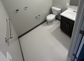 Thumbnail 12 of 22 - A bathroom with a toilet, sink, and shower.