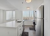 Thumbnail 14 of 50 - a white kitchen with a large window and a stainless steel refrigerator at The Zenith, Maryland