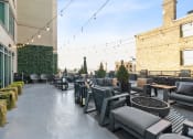 Thumbnail 47 of 50 - a rooftop patio with chairs and tables and a fire pit at The Zenith, Maryland
