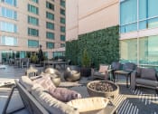 Thumbnail 45 of 50 - a lounge area with a couch and chairs in front of a tall building at The Zenith, Baltimore, Maryland
